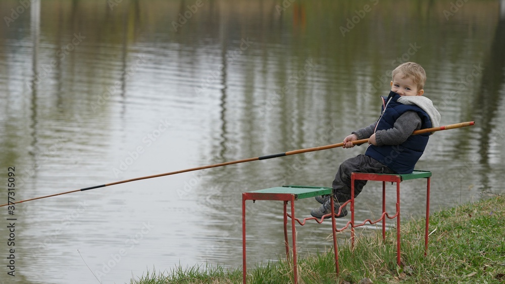 Small child learns fishing on the lake Small child learns fishing on the lake
