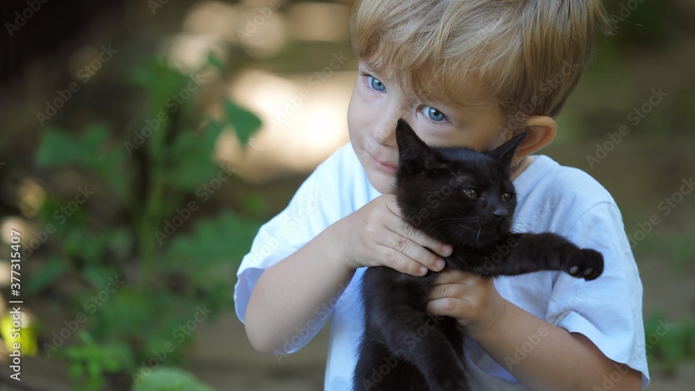 Portrait of blue eyes child lift up a black cat, face to face touching, pure animals love, Portrait of blue eyes child lift up a black cat, face to face touching, pure animals love,