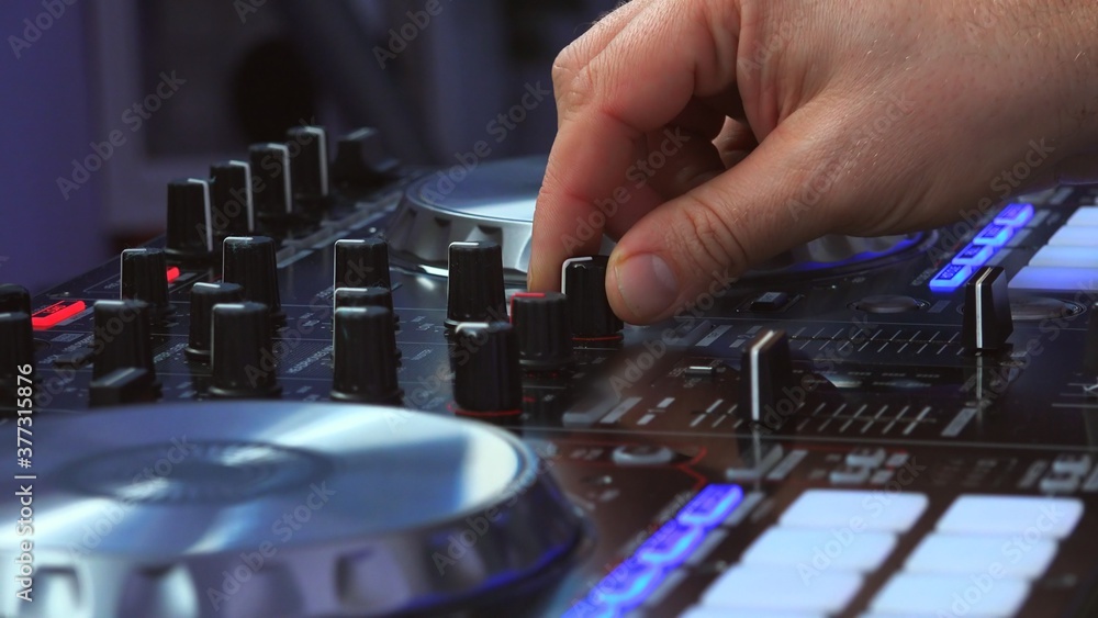 Turn on DJ turntable mixer desk, lateral view Turn on DJ turntable mixer desk, lateral view