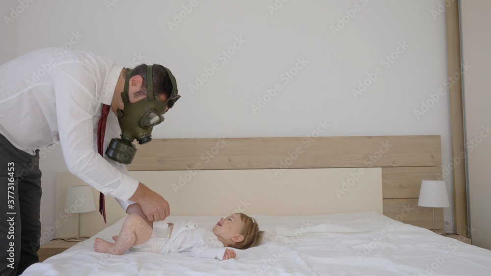 Businessman with gas mask changing baby child diaper, work from home