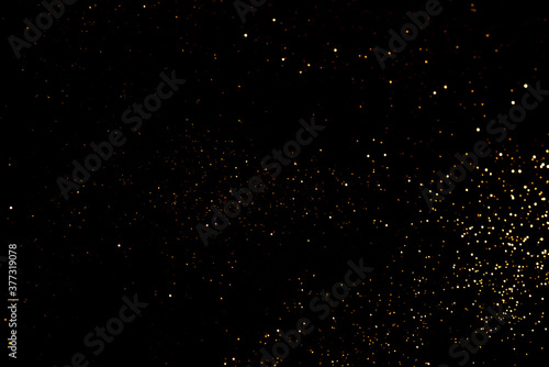 Golden abstract bokeh on black background. Holiday concept.