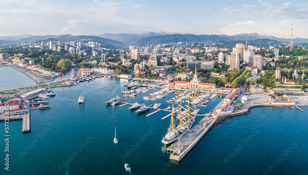 Aerial photography. The black sea coast of Russia, the city of Sochi, seaport, yachts and ships at the pier. City attraction - obrazy, fototapety, plakaty 