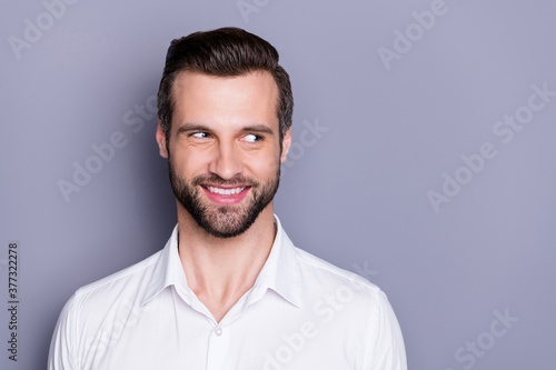 Portrait of charming charismatic real estate agent man marketer chief look copyspace listen colleagues conversation feel curious wear stylish outfit isolated over gray color background © deagreez