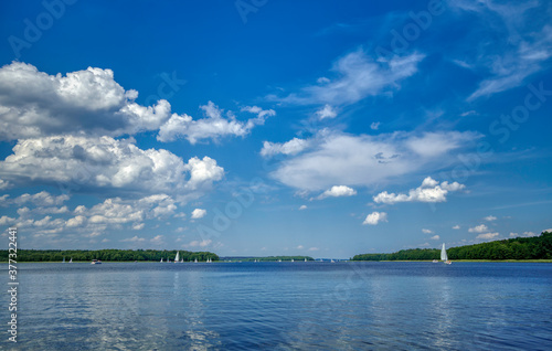 Fototapeta Naklejka Na Ścianę i Meble -  white boats sailing on the lake on a beautiful summer day (HDRi)