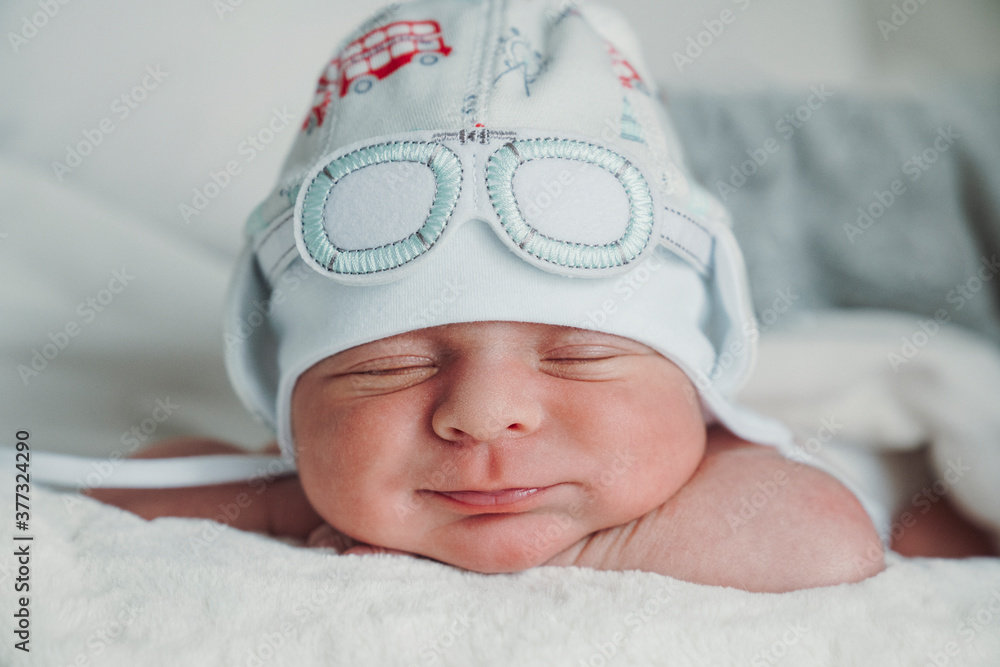 Bebe durmiendo sonriendo con gorro de tela