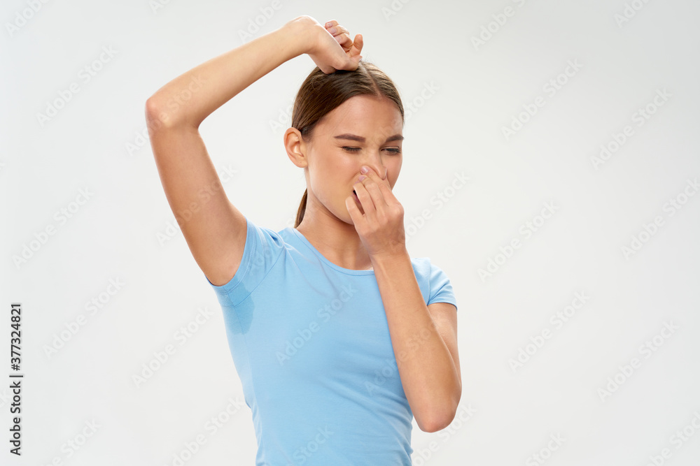 woman with sweaty armpit covering nose bad smell hygiene woman with sweaty armpit covering nose bad smell hygiene