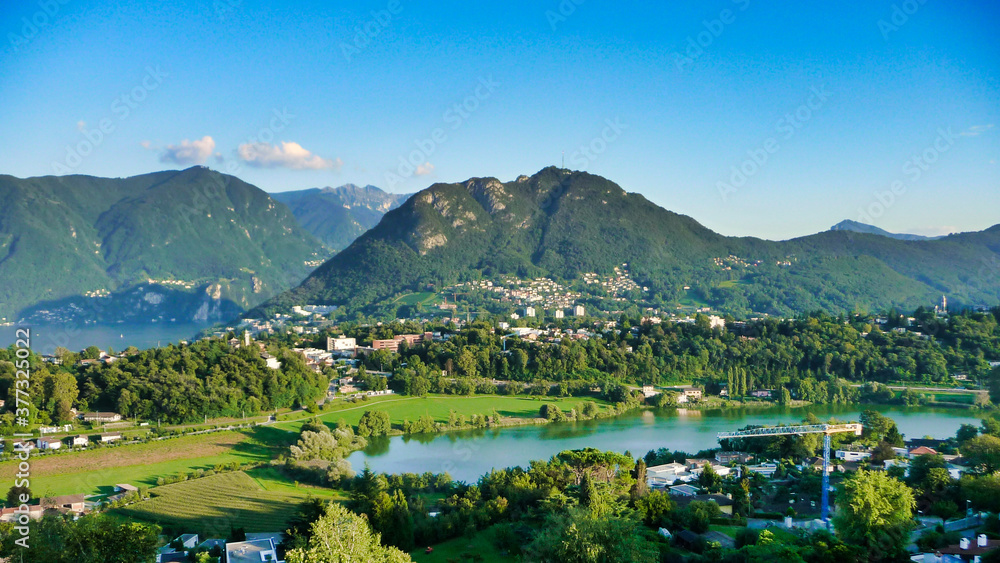 landscape with lake and mountains, lago di Muzzano lake, Lugano, Ticino, Switzerland