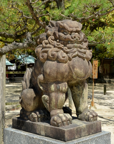 Stone lion at Sumiyoshi Shrine in Fukuoka city, Japan. This shrine is dedicated to safe travel by sea and is presumably the oldest shinto shrine in Kyushu.
