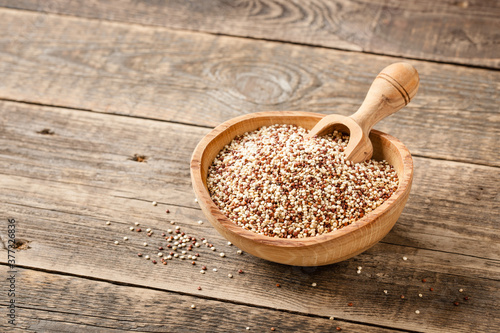 Mixed dry quinoa on wooden table