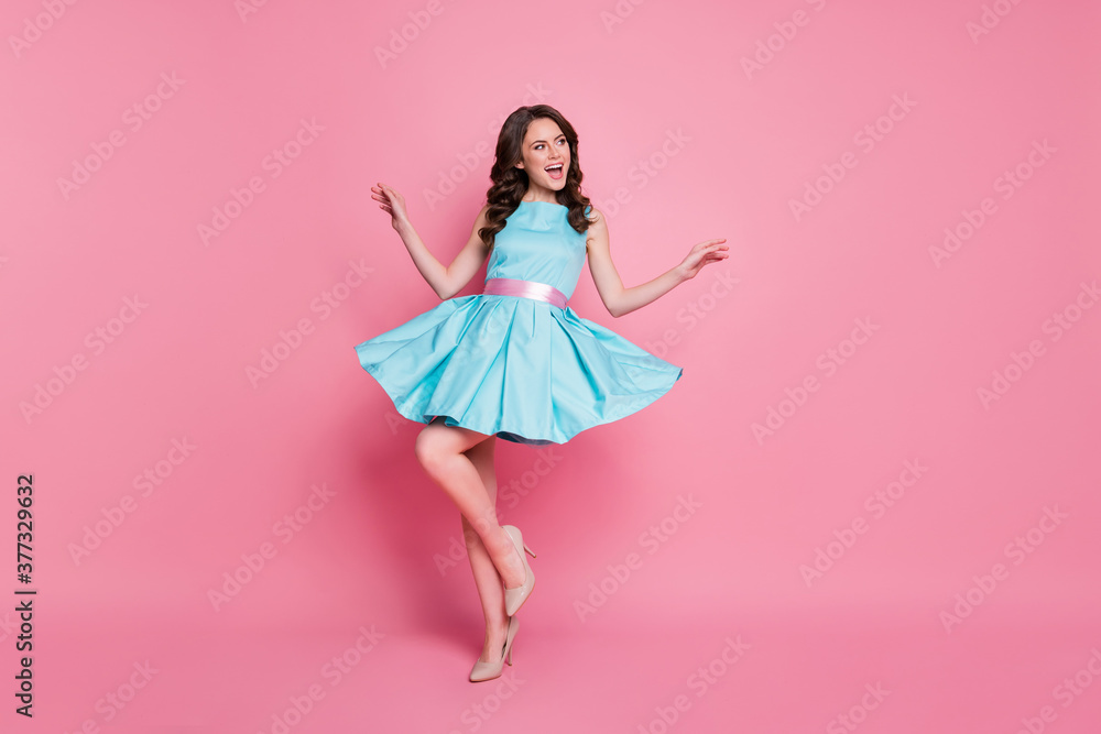Full length photo of attractive curly lady glamorous clothes event night club dancing skirt flying wear blue teal dress high-heels isolated pastel pink color background Full length photo of attractive curly lady glamorous clothes event night club dancing skirt flying wear blue teal dress high-heels isolated pastel pink color background