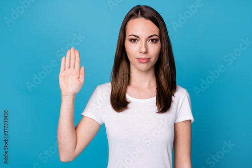 Photo of serious confident girl hold hand say stop gesture wear good look clothes isolated over blue color background