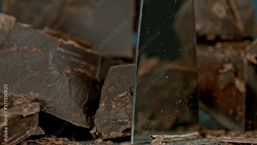 Super Slow Motion Shot of Cutting Raw Chocolate Chunk at 1000 fps. Super Slow Motion Shot of Cutting Raw Chocolate Chunk at 1000 fps.