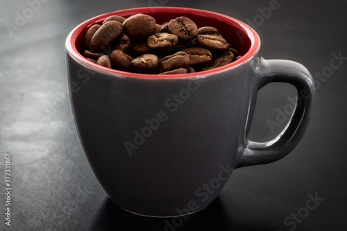 Coffee in a cup against the background of roasted coffee beans coffee on dark background.. classy coffee