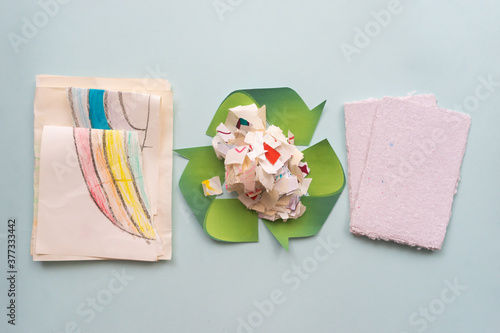 Sheets of paper and a zero waste sign are on the table. Paper recycling concept.