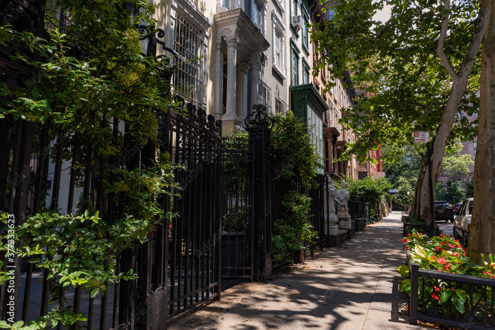 Row of Old Brownstone Homes on the Upper West Side of New York City with an Empty Sidewalk