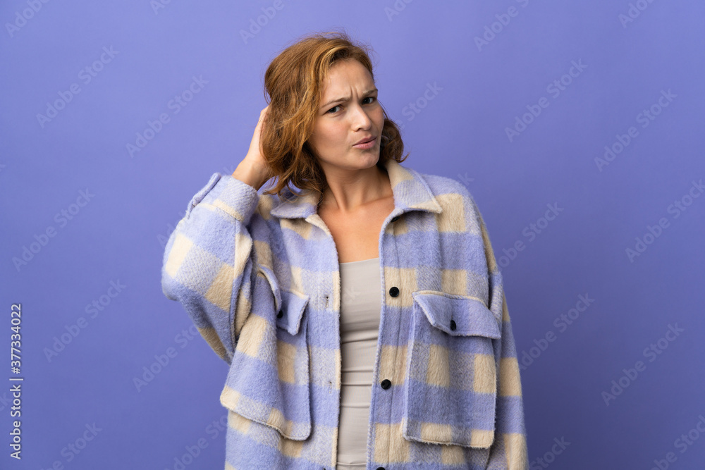 Young Georgian woman isolated on purple background having doubts Young Georgian woman isolated on purple background having doubts