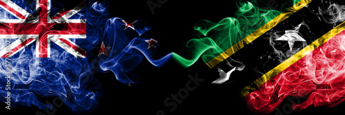 New Zealand vs Saint Kitts and Nevis smoky mystic flags placed side by side. Thick colored silky abstract smoke flags
