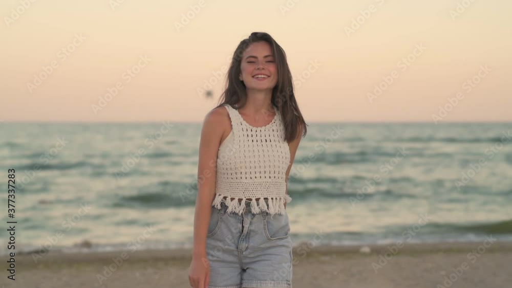 A beautiful young girl is walking on the beach A beautiful young girl is walking on the beach