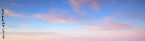 Valokuva Clear blue sky with glowing pink cirrus and cumulus clouds after storm at sunset