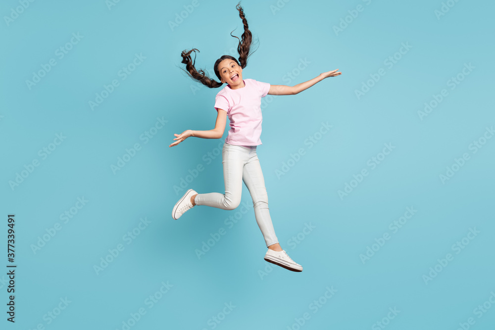 Full length body size view of her she nice attractive pretty funky childish playful comic foolish cheerful cheery girl jumping having fun fooling isolated over blue pastel color background