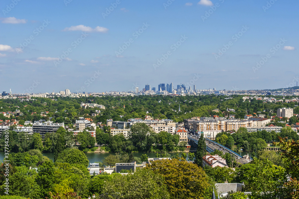 Beautiful view of valley of Seine River and panorama of Paris on backgrounds from lookout near Chateau de Saint-Germain-en-Laye in city Saint-Germain-en-Laye (13 miles west of Paris), France. Beautiful view of valley of Seine River and panorama of Paris on backgrounds from lookout near Chateau de Saint-Germain-en-Laye in city Saint-Germain-en-Laye (13 miles west of Paris), France.