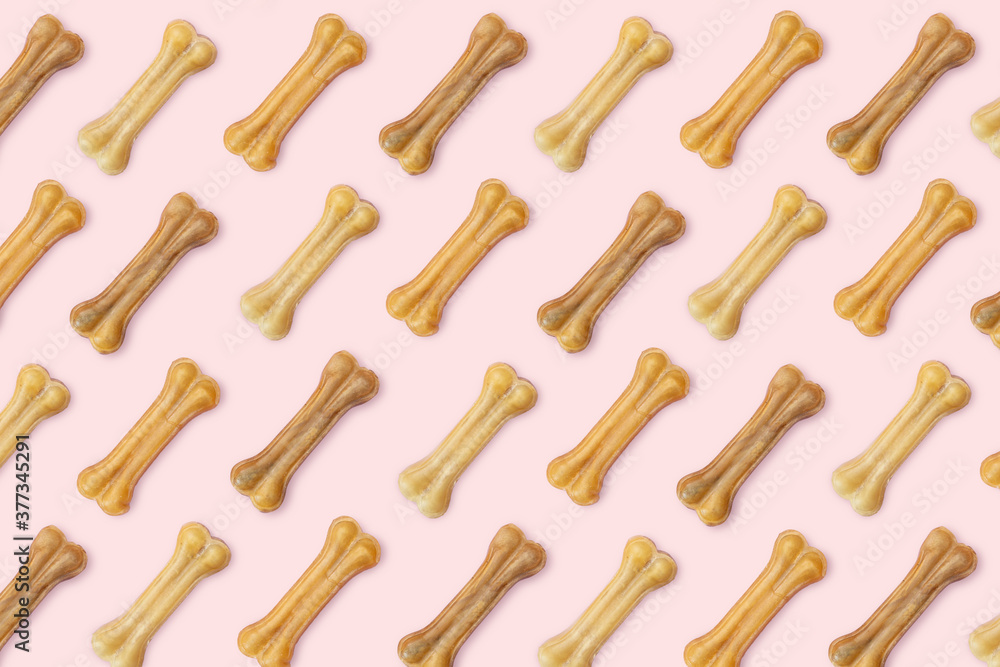 Pink background of dog goodies in the form of a bone. Pink background of dog goodies in the form of a bone.
