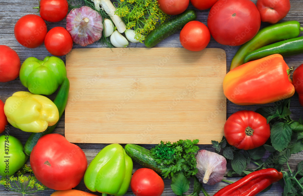 Make up with fresh vegetables tomatoes, garlic, bell peppers, hot peppers, dill, parsley and horseradish on a wooden table. Make up with fresh vegetables tomatoes, garlic, bell peppers, hot peppers, dill, parsley and horseradish on a wooden table.