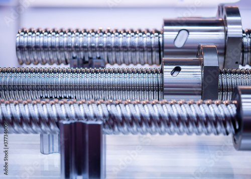 Steel rod with a screw thread and a metal round detail, in industrial applications.close-up.