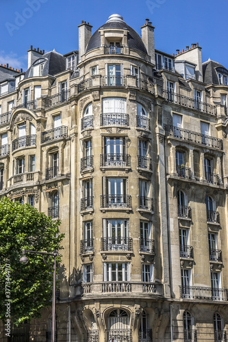 Architecture of Paris: Old French house with traditional balconies and windows. Paris, France. © dbrnjhrj