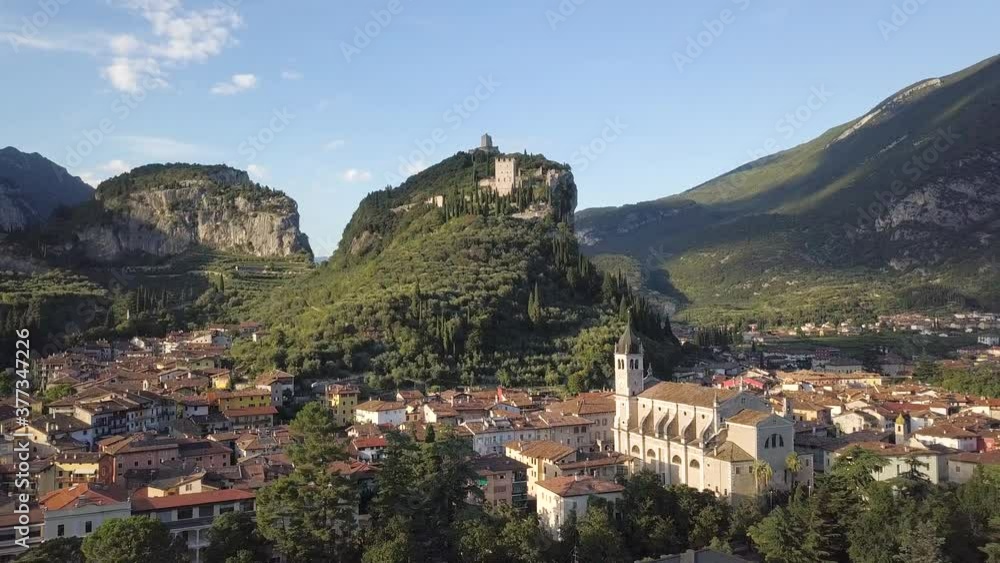 Aerial shot of a historic town in Italy, with a building on a cliff rock - Arco, Riva del Garda, Trentino Aerial shot of a historic town in Italy, with a building on a cliff rock - Arco, Riva del Garda, Trentino