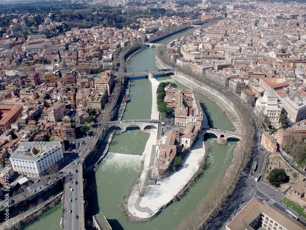 Obraz premium Aerial view of the Tiber island and buildings along the river edge, Rome Italy