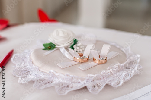 wedding rings on a white stand at the ceremony in the registry office