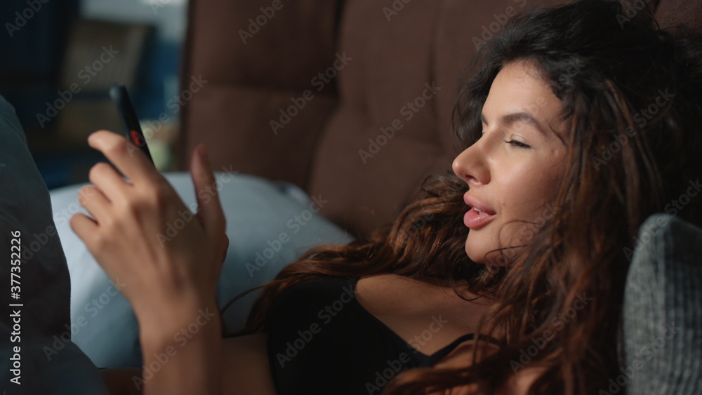 Fancy woman putting aside mobile phone in bed. Gorgeous enjoying free time home Fancy woman putting aside mobile phone in bed. Gorgeous enjoying free time home