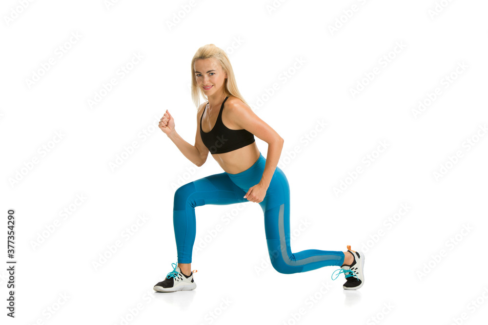 Strong, flexible. Beautiful female fitness coach practicing on white studio background, showing exercises. Caucasian blonde model in sport outfit. Professional occupation, active and healthy lifestyle Strong, flexible. Beautiful female fitness coach practicing on white studio background, showing exercises. Caucasian blonde model in sport outfit. Professional occupation, active and healthy lifestyle