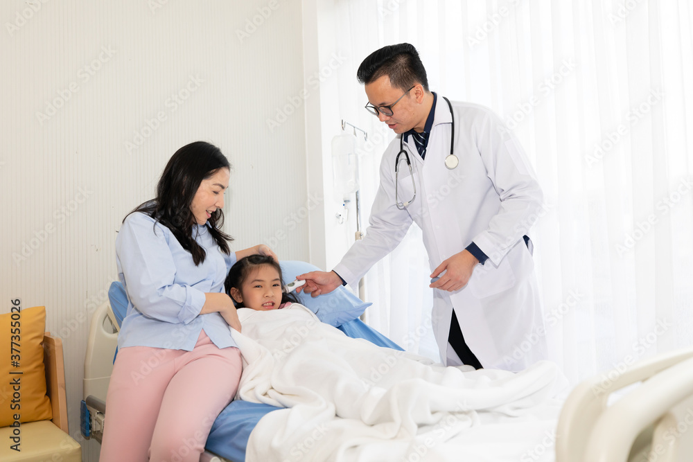 asian doctor checking temperature to child's ear and mother by her side in hospital asian doctor checking temperature to child's ear and mother by her side in hospital