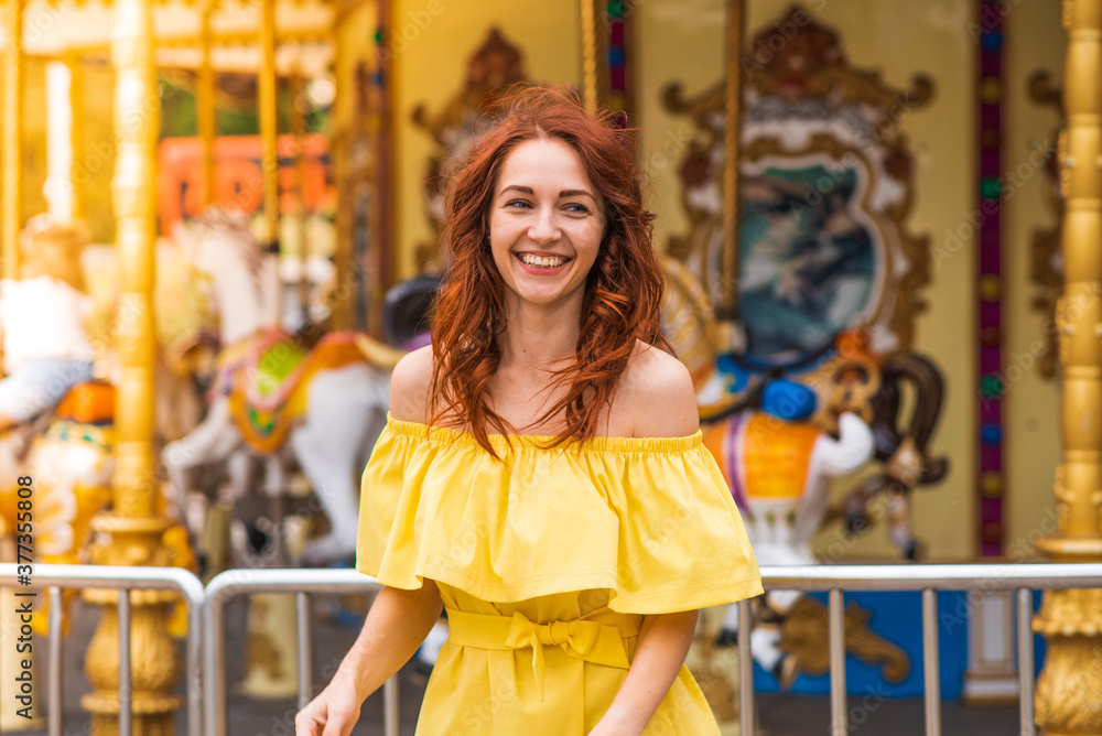 Happy beautiful redhead girl walking in the park Happy beautiful redhead girl walking in the park