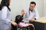 asian doctor give high five with little girl after medical checkup