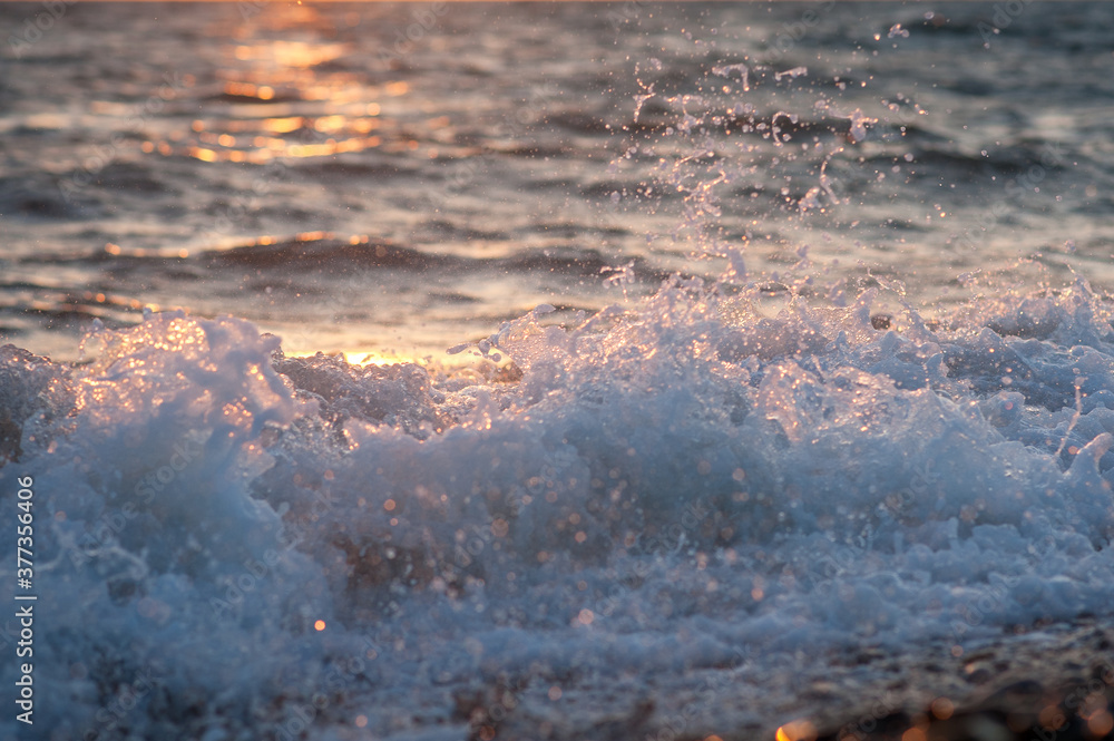 Splashing water in the rays of the setting sun.