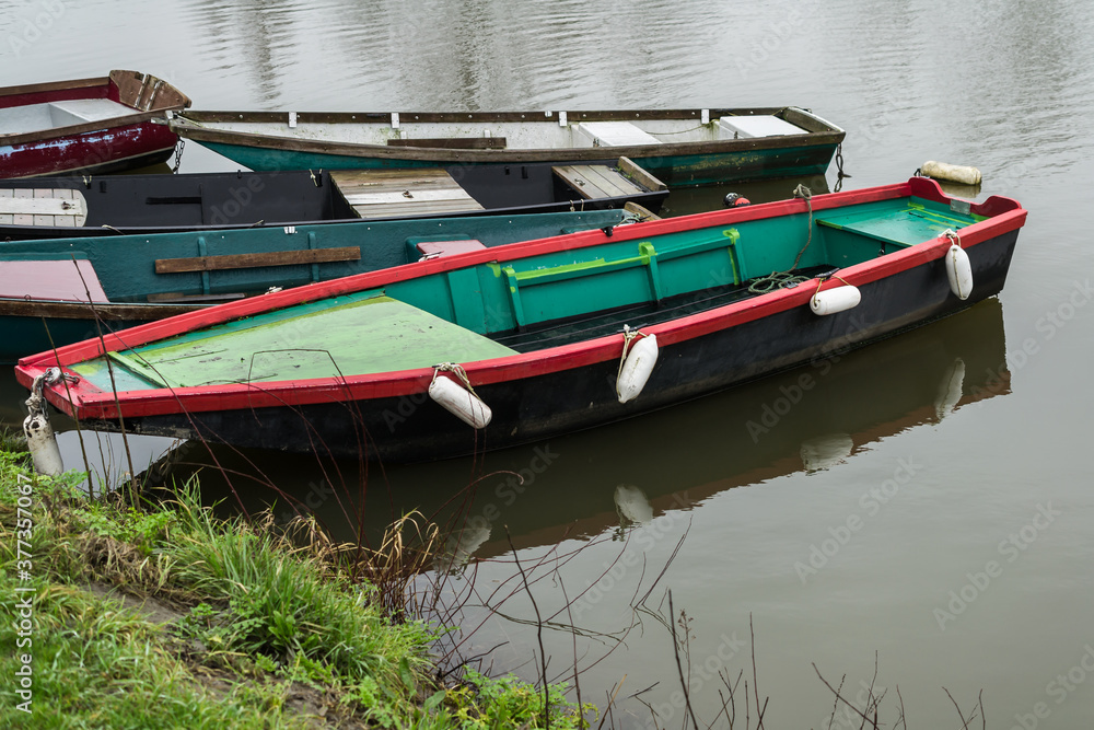 Typical hobby fishing boat at a mooring in a river.