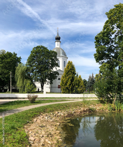 Temple of Boris and Gleb on the shore of the pond in the Belkino Manor in Obninsk. Ð¡hurch next to the pond.  Summer landscape. photo