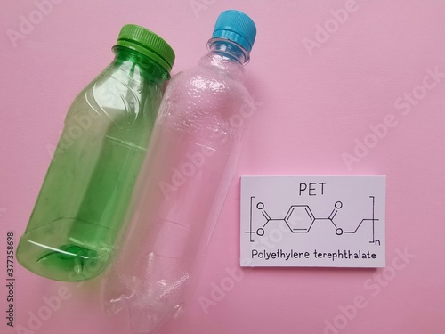 Structural chemical formula of polyethylene terephthalate molecule with plastic bottles made from PET. Polyethylene terephthalate (PET, PETE) is the most common thermoplastic polymer. photo