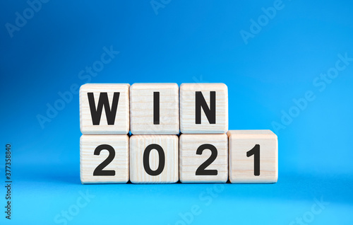 WIN 2021 years on wooden cubes on a blue background