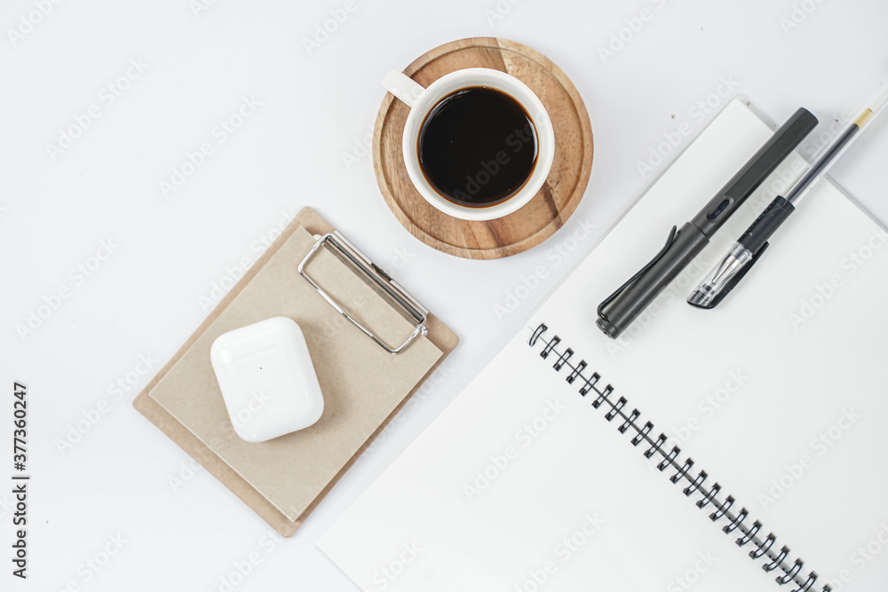 Workplace in office with white desk. Top view from above of keyboard with notebook and coffee. Space for modern creative work of designer. Flat lay with blank copy space. Workplace in office with white desk. Top view from above of keyboard with notebook and coffee. Space for modern creative work of designer. Flat lay with blank copy space.