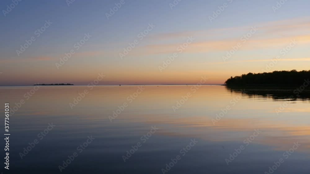 beautiful sunset on a quiet lake, the sky is reflected in the water beautiful sunset on a quiet lake, the sky is reflected in the water