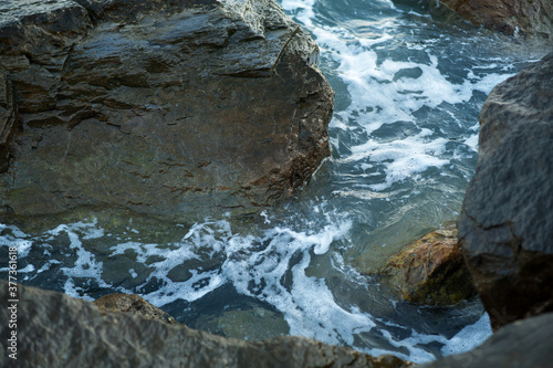 Fototapeta Naklejka Na Ścianę i Meble -  A piece of sea and stones, splashes, water, neutral background