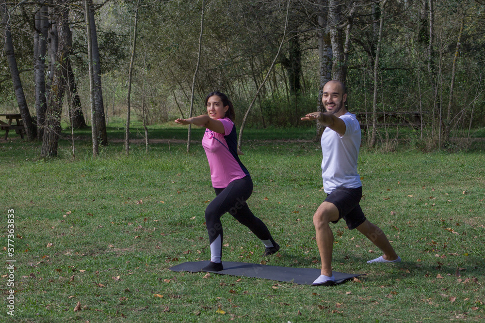 Young male and female practicing Yoga on the Nature. Young male and female practicing Yoga on the Nature.