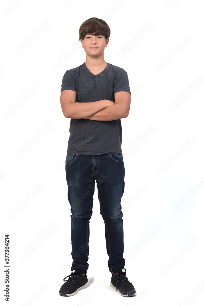Naklejka premium portrait of a teenage boy on white background with crossed arms
