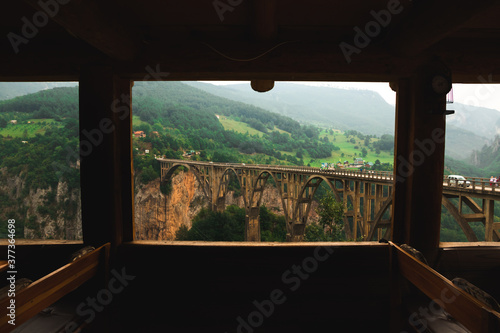 Atmospheric photo while traveling in the mountains of montenegro, a bridge in a frame, a landscape framed by a cafe, a view of nature photo