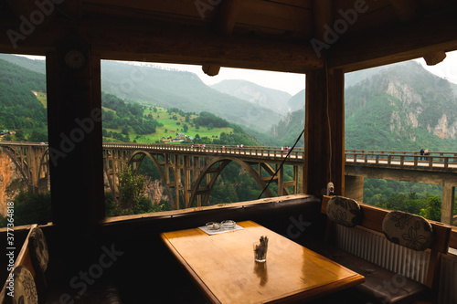 View from the cafe on the mountain, beautiful and impressive landscape of the mountains and the bridge © FellowNeko