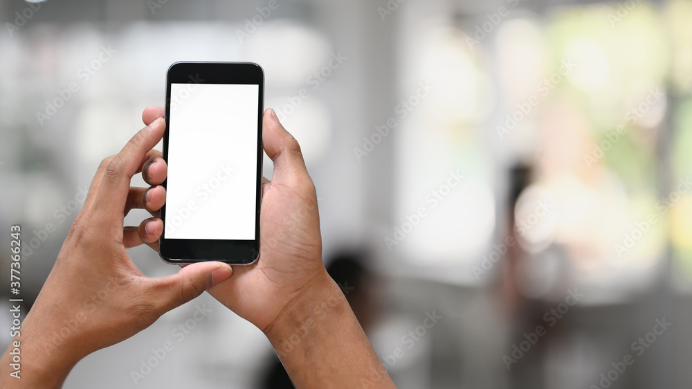Closeup hands holding empty screen of smartphone with blur background. Closeup hands holding empty screen of smartphone with blur background.